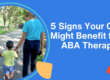 Two therapists in light blue shirts walk with a child along a tree-lined path. Abstract shapes in pastel colors frame the text: '5 Signs Your Child Might Benefit from ABA Therapy.